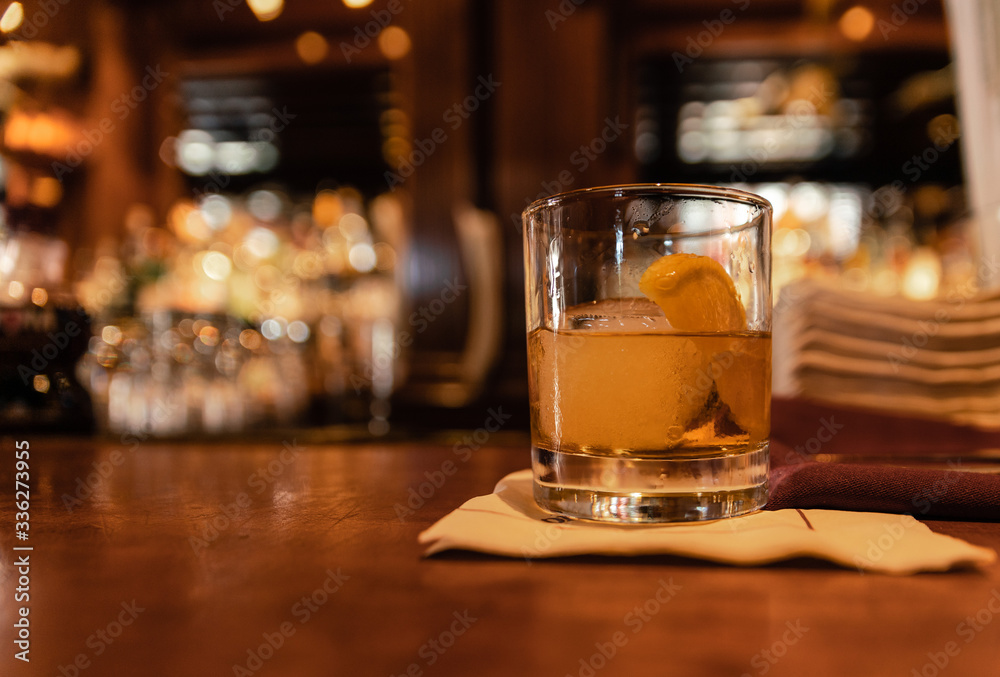 a glass of whiskey on a bar counter a glass of whiskey on a bar counter