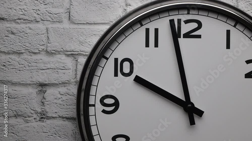 Wallpaper Mural The Time On The Clock Ten.  A Clock On A White Brick Wall With The Black Arrow Running In The Background Of The Arabic Numerals. Timelapse.. Torontodigital.ca