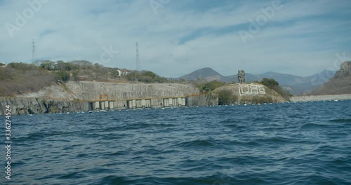 View of Chicoasen Dam from reservoir with Statues and CFE Sign photo