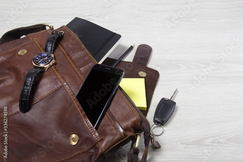 Open men's bag, men's accessories. Space for text. Things fell out of the bag.