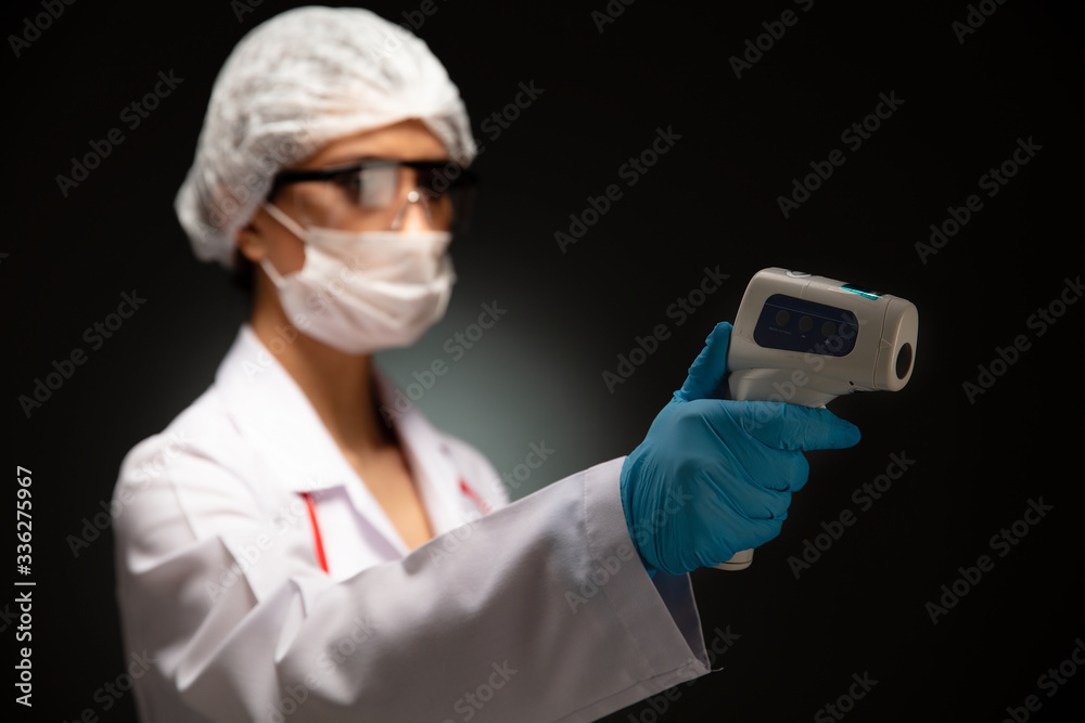 Doctor using infrared thermometer. Doctor using infrared thermometer.