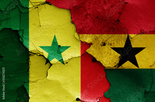 flags of Senegal and Ghana painted on cracked wall