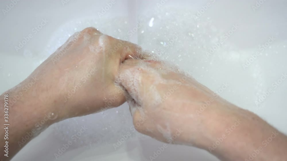 Man carefully washing hands with disinfectant soap. Man carefully washing hands with disinfectant soap.