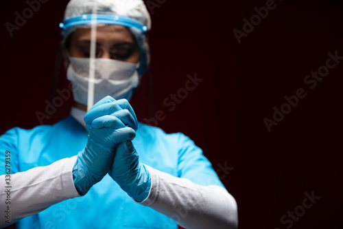 Healthcare worker is praying for stop to spreading of this virus, you no exit home