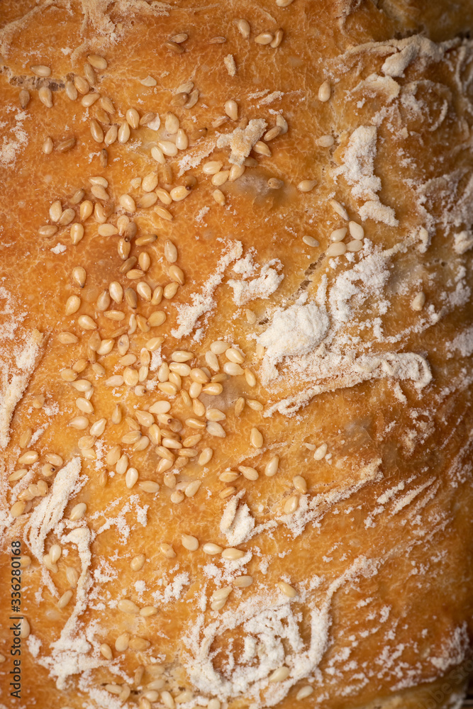 White bread sprinkled with sesame seeds close-up. Fresh, texture, food, bakery, cooking, delicious White bread sprinkled with sesame seeds close-up. Fresh, texture, food, bakery, cooking, delicious