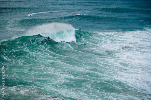 Photography Breathtaking surfing action at Praia do Norte in Nazare, Portugal