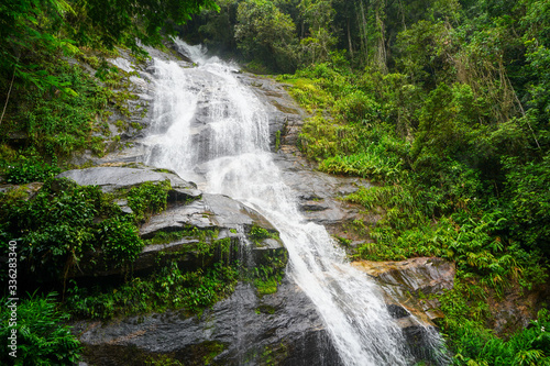Beautiful waterfall near the rock in Rio de Janeiro's Tijuca Forrest in Brazil