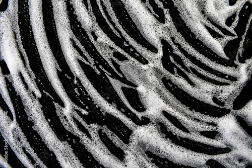 White foam bubbles on a black background