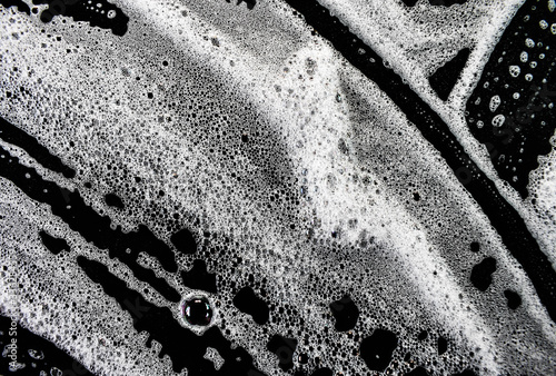 White foam bubbles on a black background
