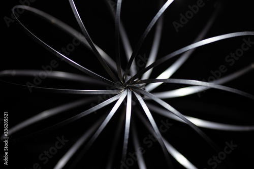 the abstract metal silver toy on a  black background 