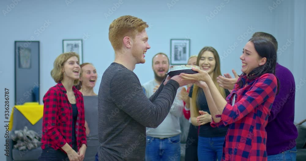 Girl throws a cake in the face of a guy. Guy carries a cake for the