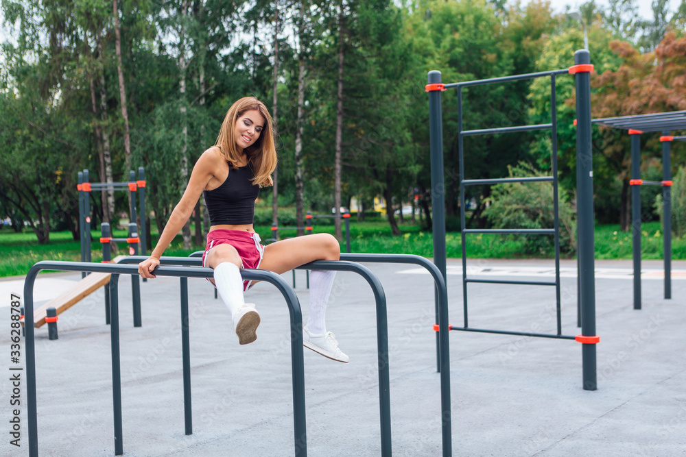 Fototapeta premium Woman relaxing after a evening workout outdoors