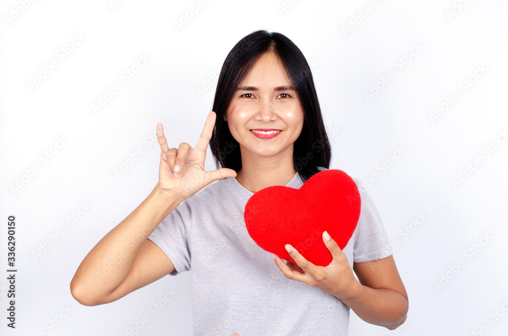 Cute asian woman portrait smile and show love hands gesture and hand holding red heart on white backgrounds Cute asian woman portrait smile and show love hands gesture and hand holding red heart on white backgrounds
