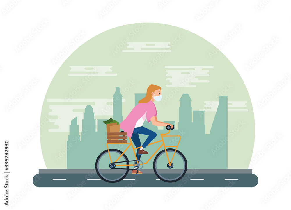 woman using face mask in bicycle transport groceries