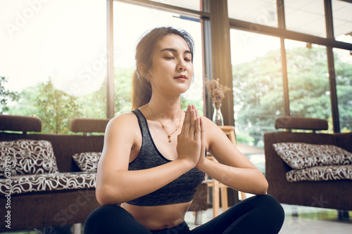 Young Asian woman yoga practice at home. Woman practice yoga with natural at home concept. Free Download Young Asian woman yoga practice at home. Woman practice yoga with natural at home concept. - GFXLoad