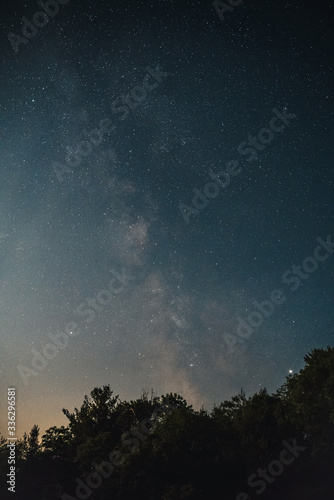Image of the night sky with milky way, clouds, and stars