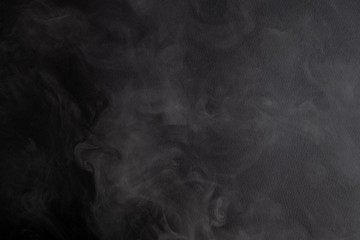the abstract flow of smoke from a black background.