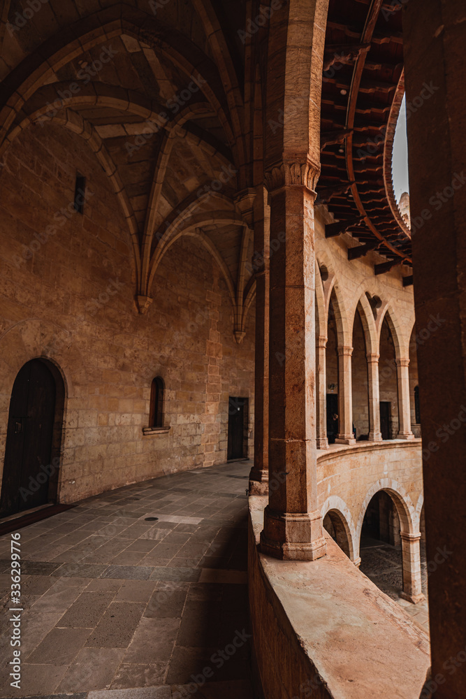 Palma de Mallorca, Spain - 03/03/2020: Inside the court of the circular gothic castle 'Castell de Bellver', with columns and arches.