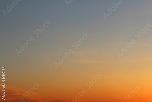 Sun below the horizon and fiery dramatic orange sky at sunset or dawn backlit by the sun. Place for text and design.
