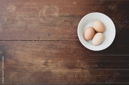 eggs in a tiled bowl with a wooden background