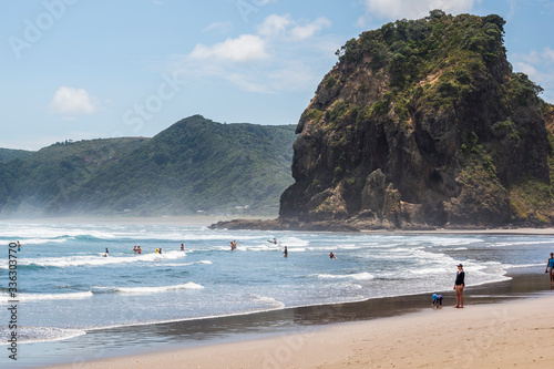 People swimming in the sea in Piha beach photo