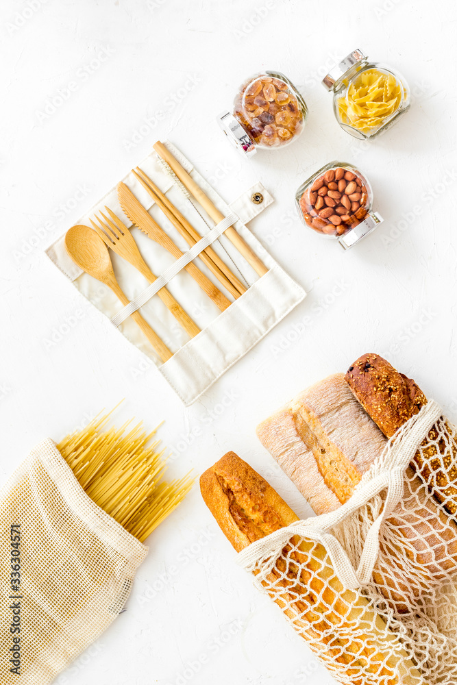 Glass jars, cotton bags on white background, top view. Eco friendly concept for kitchen - food storage Glass jars, cotton bags on white background, top view. Eco friendly concept for kitchen - food storage