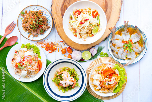 Fototapeta Naklejka Na Ścianę i Meble -  Papaya salad thai and northeast food ,Thai food served on dining table ,Tradition northeast food Isaan delicious on plate with fresh vegetables - Many variety various Thai menu Asian food on a wooden 