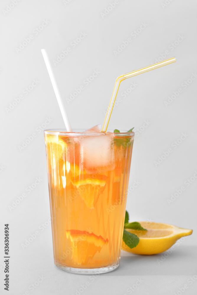 Glass of tasty cold ice tea on grey background Glass of tasty cold ice tea on grey background