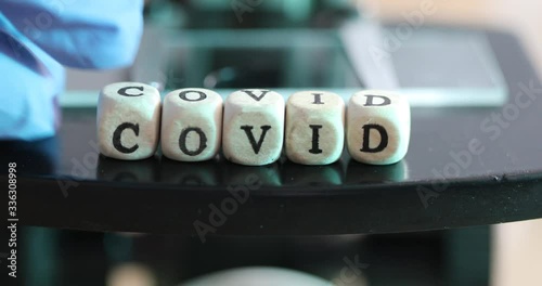 Close up of examining of test sample under the microscope in laboratory.