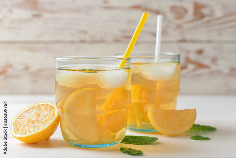 Glasses of tasty cold ice tea on white wooden background Glasses of tasty cold ice tea on white wooden background
