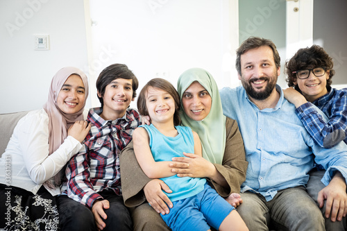 Happy Muslim family portrait on sofa photo