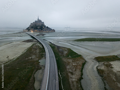 Low tide at early morning Mont-Saint Michel abbey, France photo