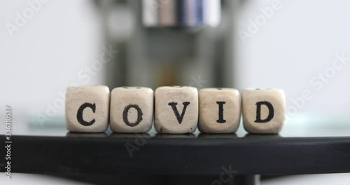 Close up of examining of test sample under the microscope in laboratory.