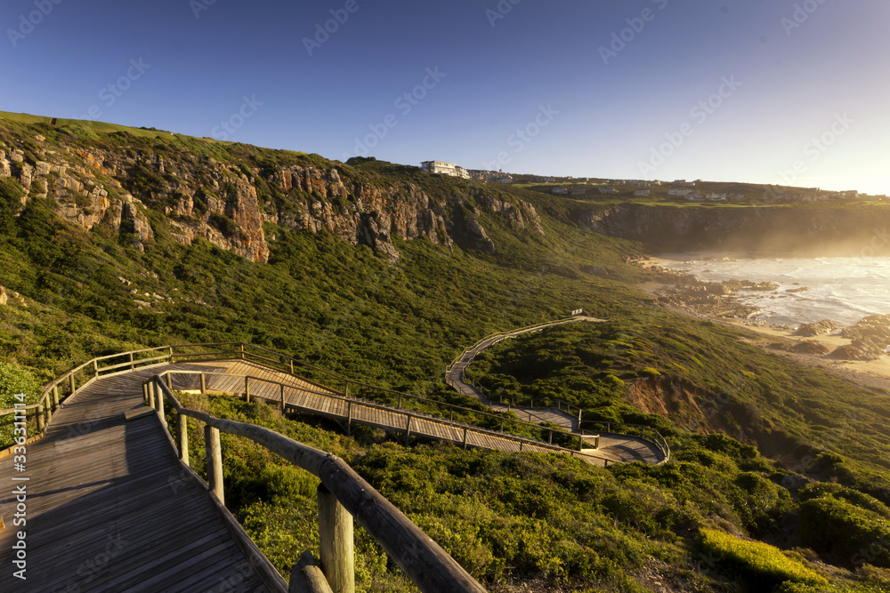 Wooden walkway down to beach cliffs 
