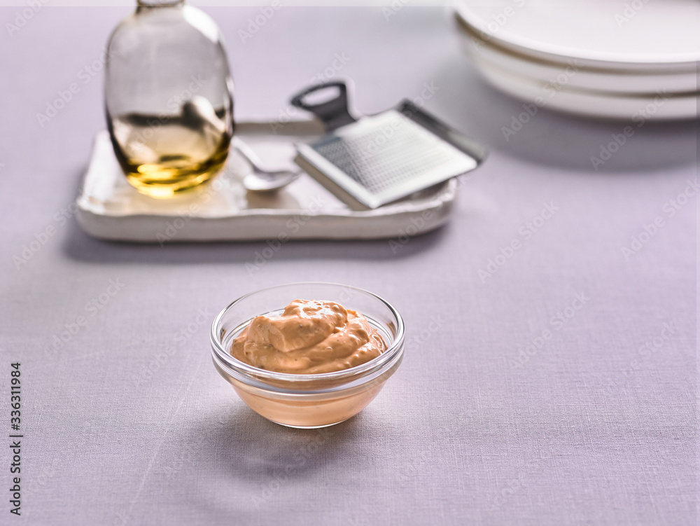 cheese sauce in a bowl on the background of the kitchen