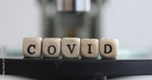 Close up of examining of test sample under the microscope in laboratory.