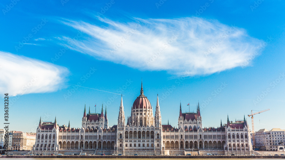 Hungarian parliament building with beautiful clouds in sunny day in Budapest