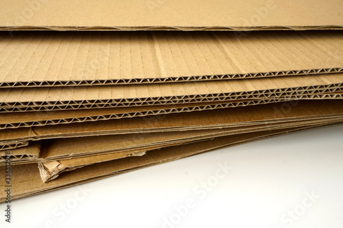 Close-up of stacked corrugated cardboard on white background.