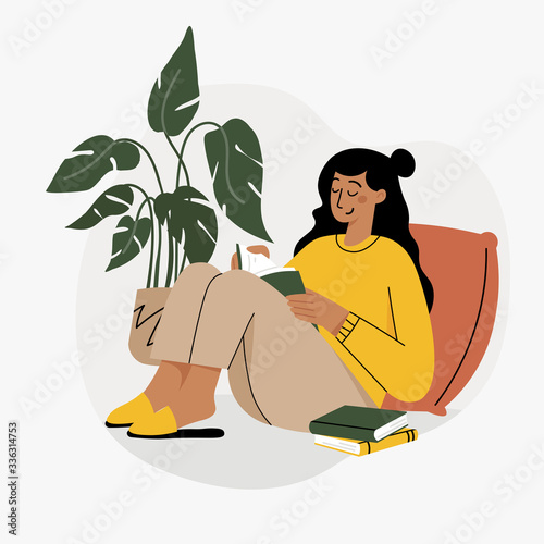 Girl reading a book and resting concept. Woman self isolation in her home 