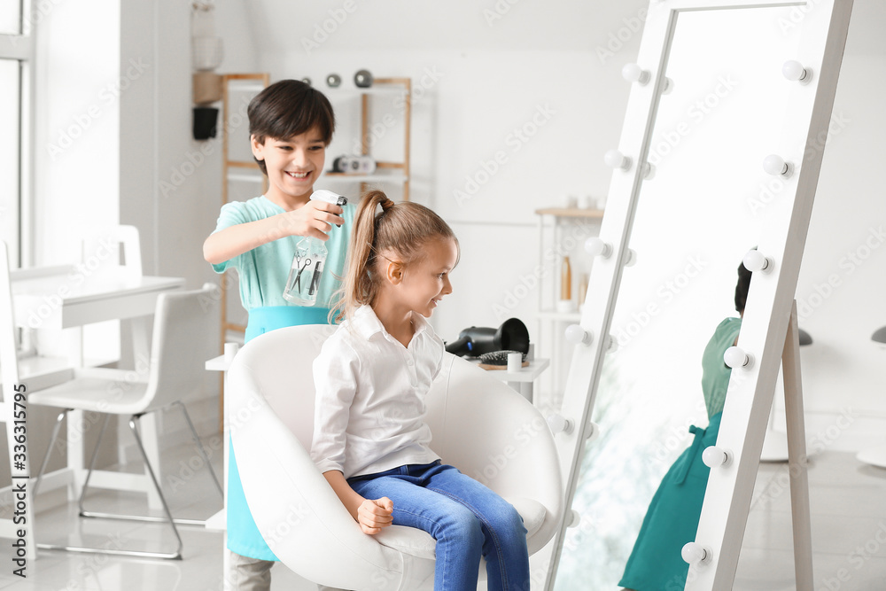 Cute little hairdresser working with client in salon Cute little hairdresser working with client in salon