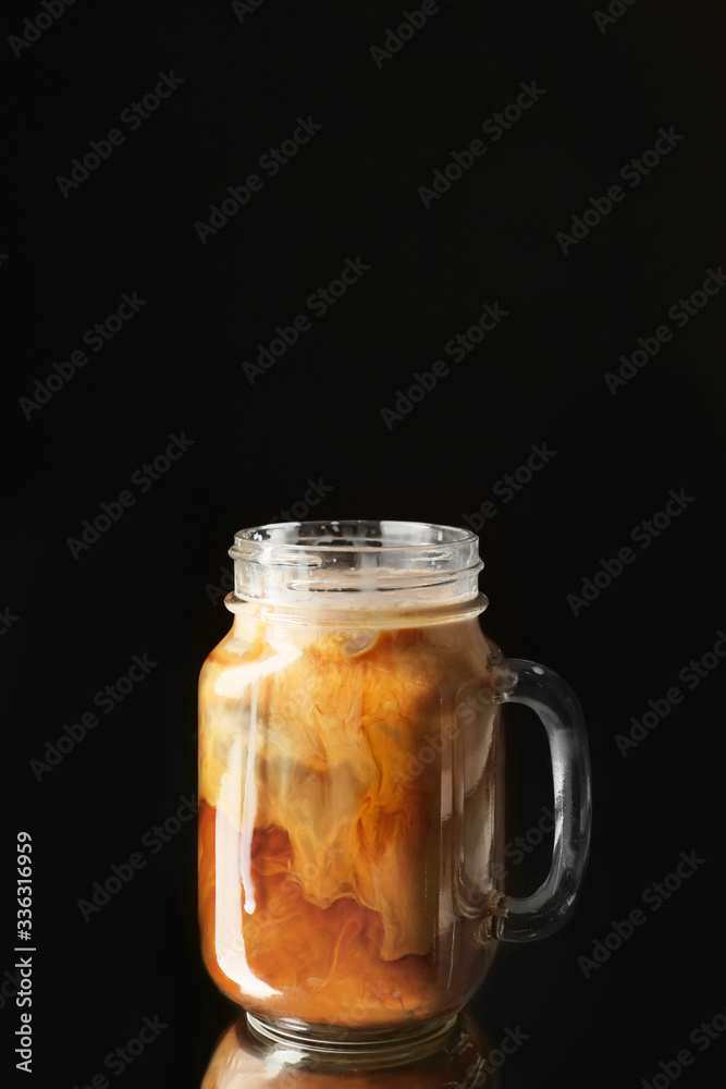 Mason jar with iced coffee on dark background Mason jar with iced coffee on dark background