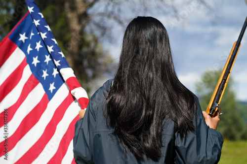 Mexican Woman's Back, Holding American Flag and Rifle in Hands photo