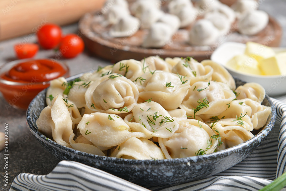 Plate with tasty dumplings on table