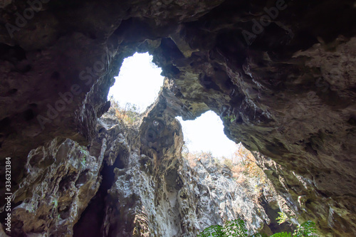 The light shining through trees from top to bottom inside the cave at Phraya Nakhon Cave National Park , Prachuap Khiri Khan , Thailand.