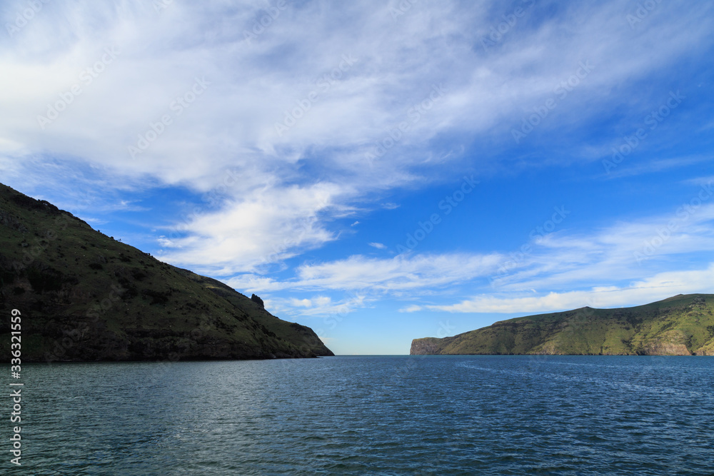 The entrance to Akaroa Harbour,  Banks Peninsula, New Zealand. To the left is Akaroa Head and Timutimu Head is on the right