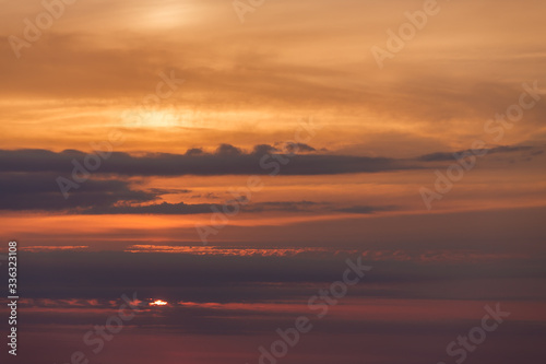 The sky at sunset, with the sun, wave, orange sky, sea coast