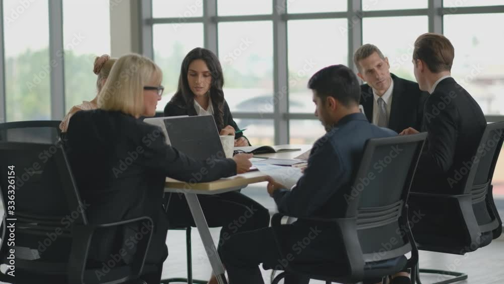 Business man discuss with his team about the project with their meeting and they look seriously with their work. Business man discuss with his team about the project with their meeting and they look seriously with their work.