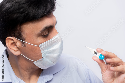 Portrait of casual middle-eastern man wear protection mask with serious eyes. Medical and healthcare of covid19 concept. Man checking temperature with serious face with mask.
