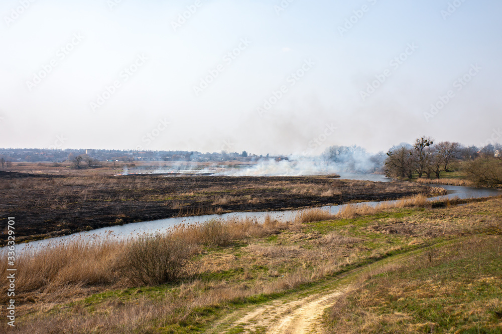 Fields are burning. Pollution of air with smoke. Harmful for environment. Illegal actions of farmers.