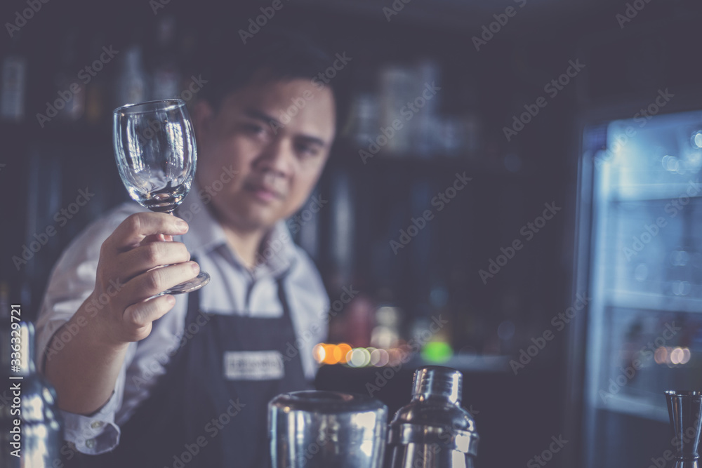 Bartenders mix drinks and serve them to customers